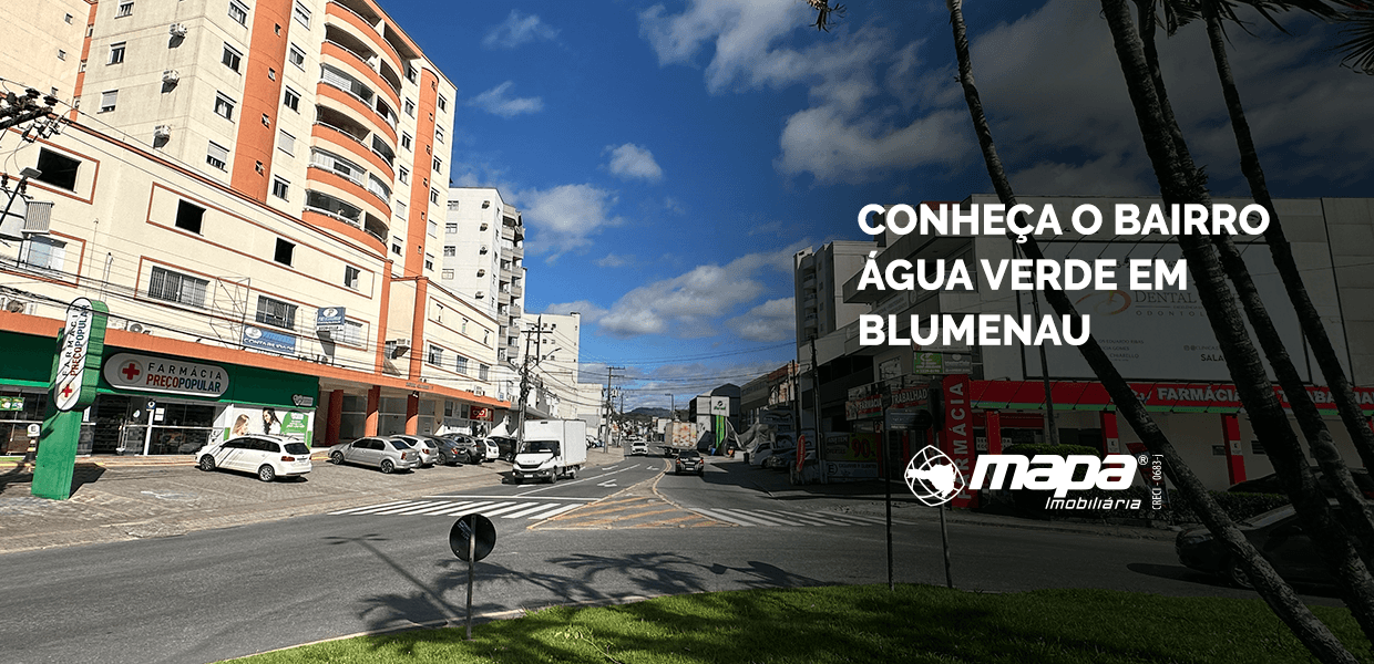 Capa do artigo Conheça o bairro Água Verde em Blumenau, com foto de avenida comercial, prédios e identificação da imobiliária.